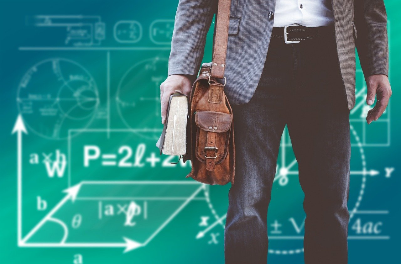 Person standing in front of a chalkboard with math formula